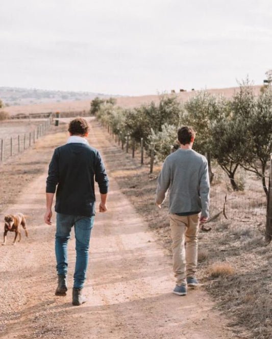 Brothers At War walking through vineyard